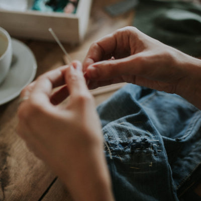 Person working with fabric on a wooden table