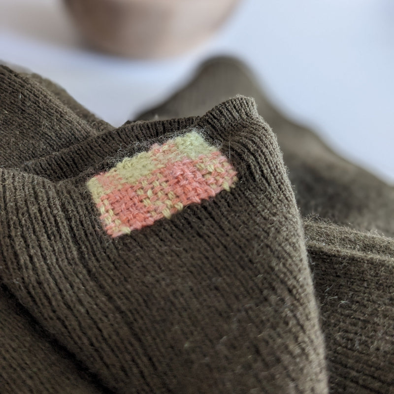 Brown fabric with a colorful patch on a blurred background