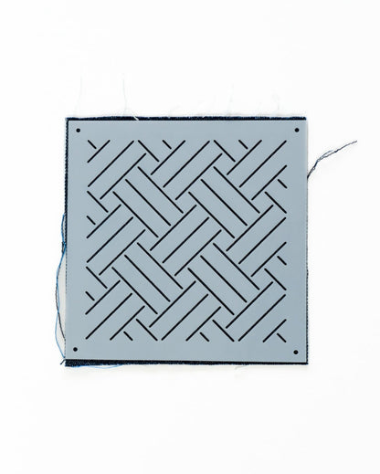 plastic wickerwork stencil on indigo swatch