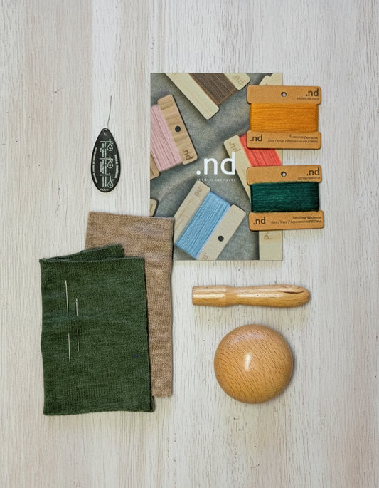 Cashmere repair kit with cashmere thread, cashmere practice patches, ball point needles, a threader and a darning mushroom