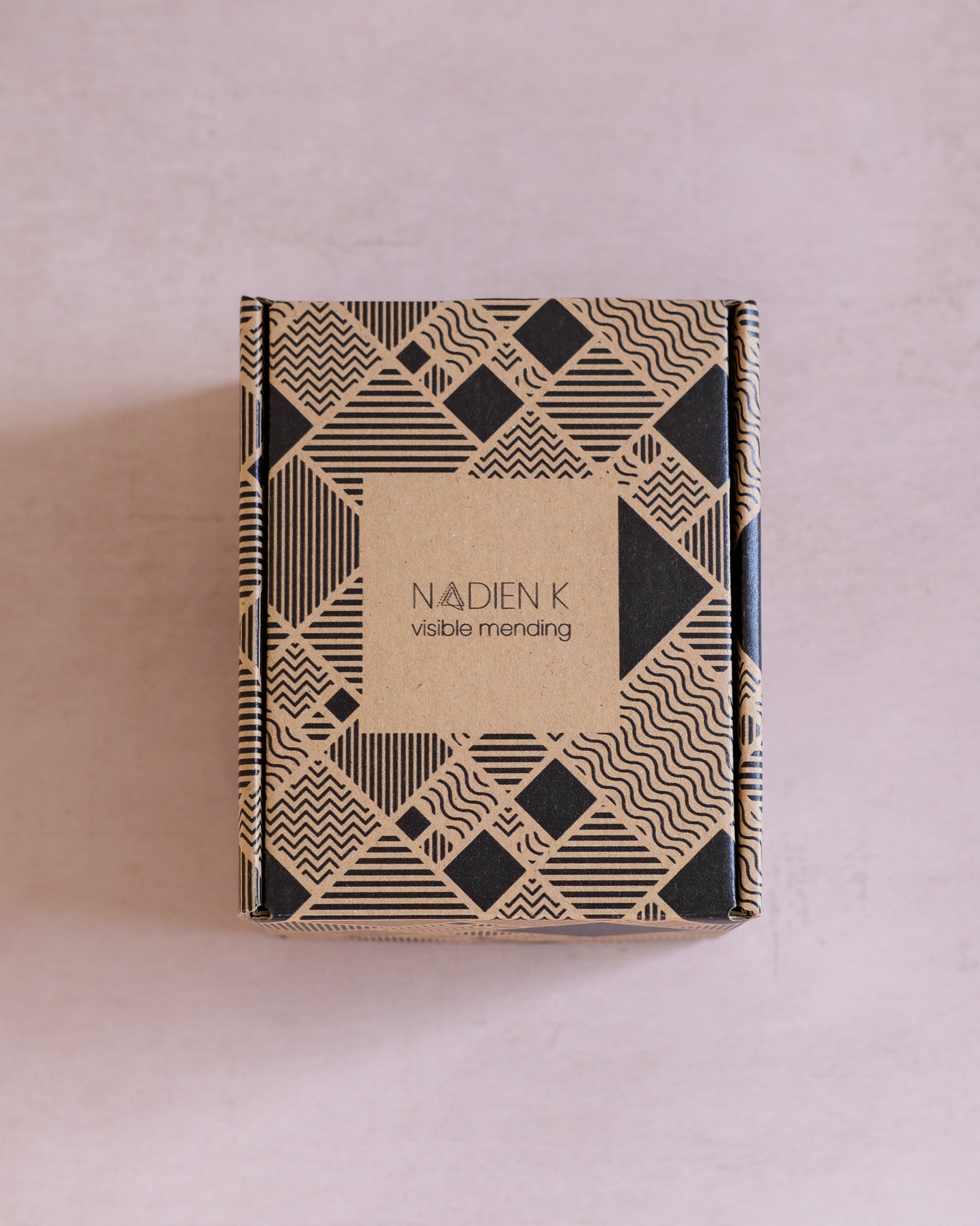 Cashmere mending kit containing a wooden darning mushroom, cashmere practice swatches, a wool comb, and cashmere mending wool